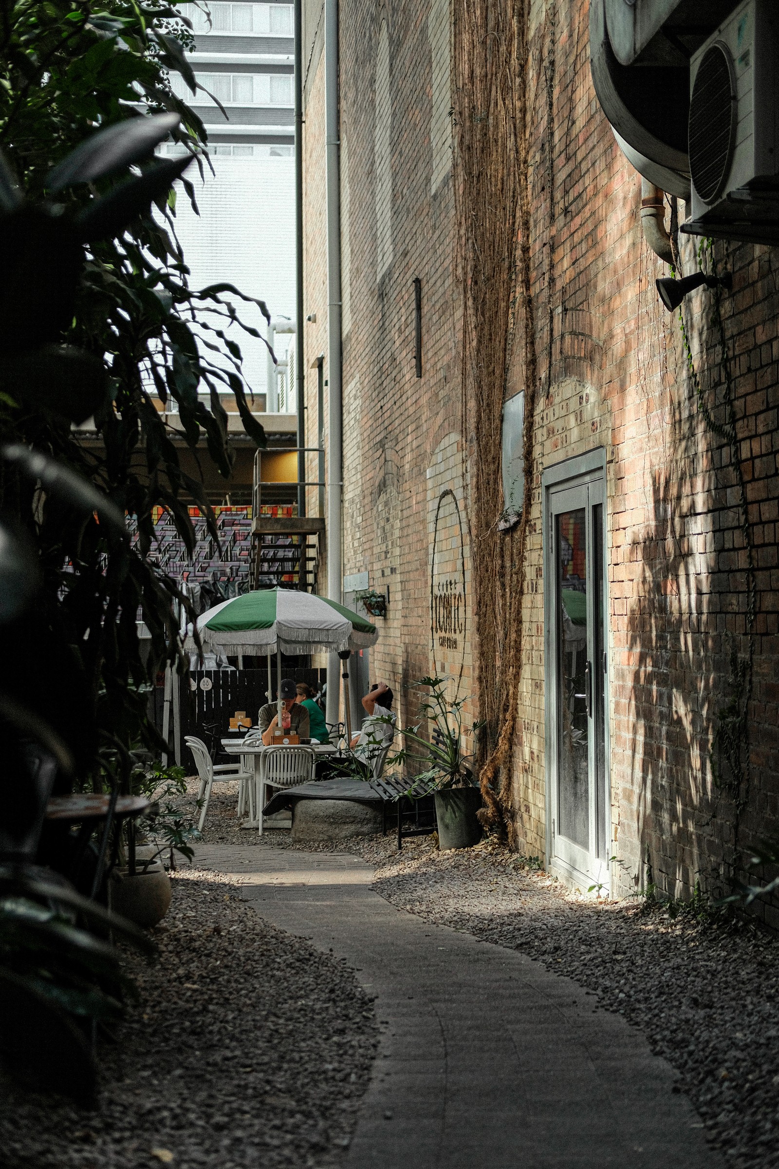 Sunlight on the brick passage and Coffee Iconic wall sign