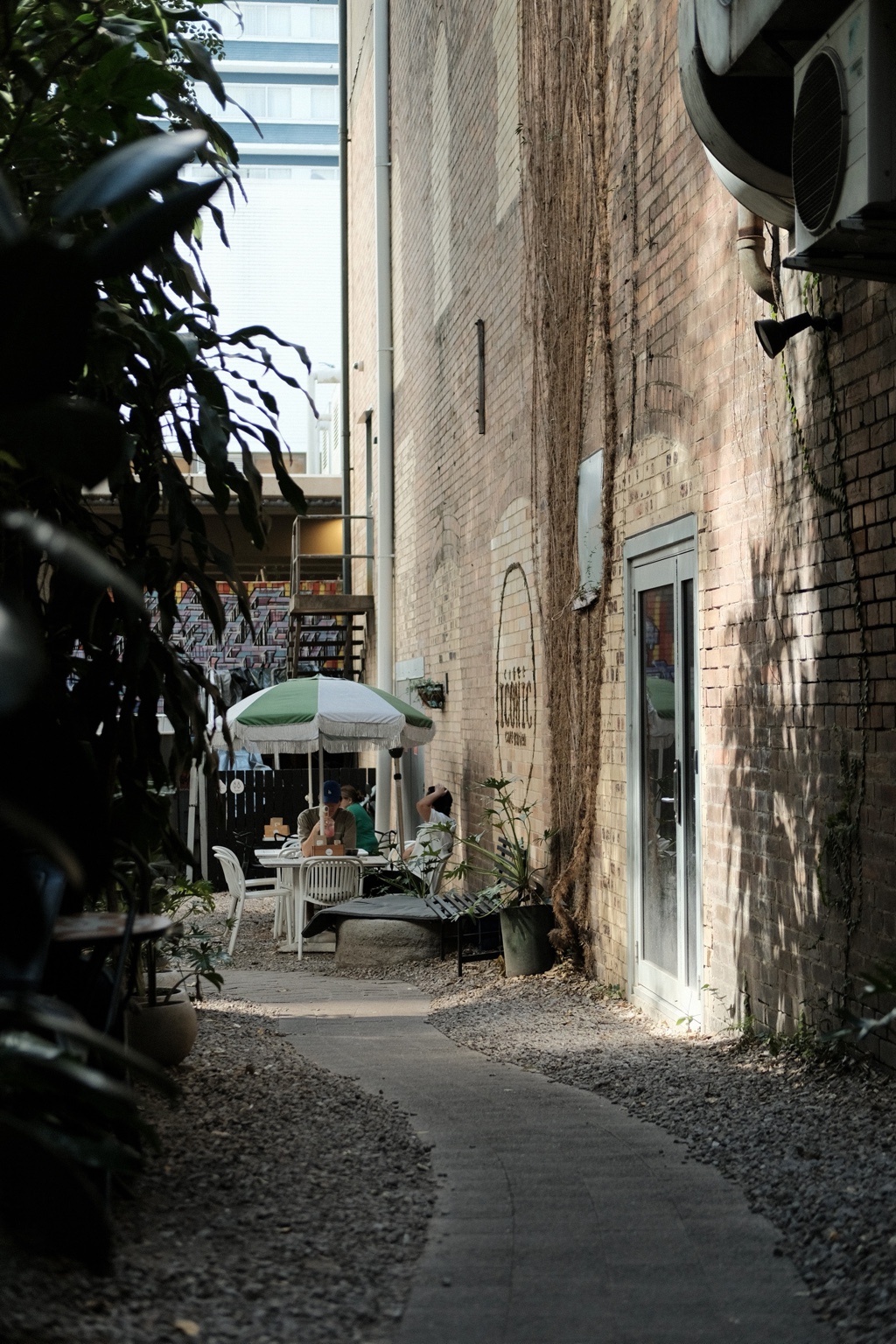 The brick passage between the street and the hidden courtyard